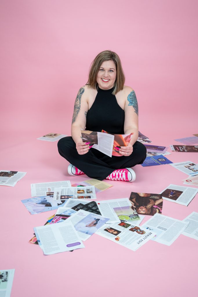 Amie Sitting on Floor with Magazines spread around her