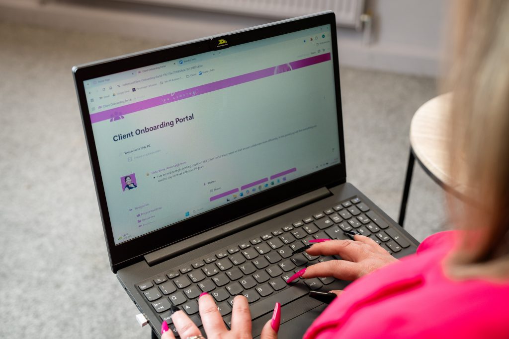 Amie typing into her laptop